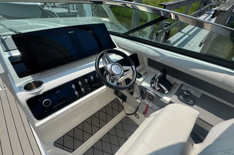 Slide: The Image of 2025 Sea Ray SLX 310 Outboard helm with modern controls and sleek design. - 34
