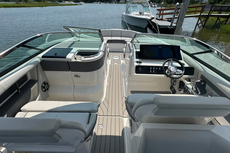 Slide: The Image of 2025 Sea Ray SLX 310 Outboard boat interior with sleek design and modern dashboard. - 26