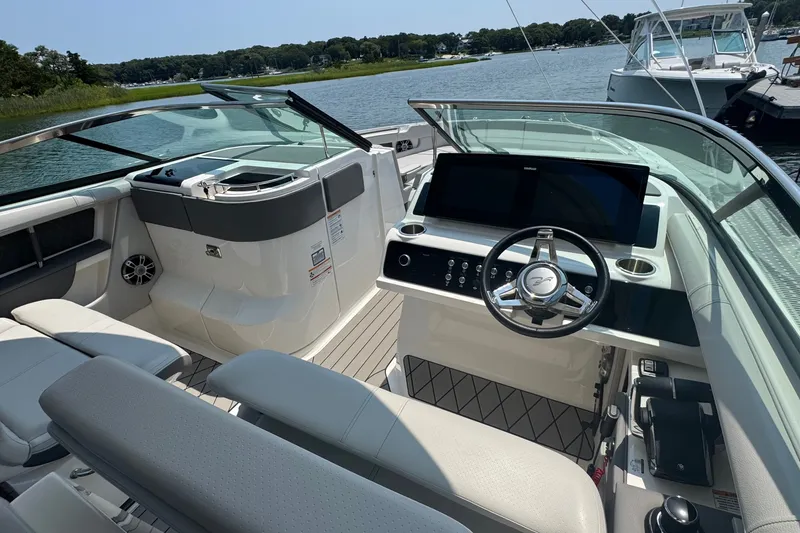 Slide: The Image of 2025 Sea Ray SLX 310 Outboard boat interior with modern helm and luxurious seating. - 36