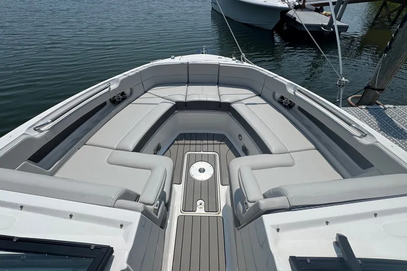 Slide: The Image of 2025 Sea Ray SLX 310 Outboard boat with spacious seating and sleek design on the water. - 43