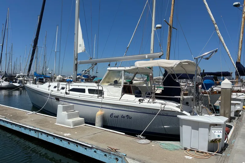 Slide: The Image of 2001 Catalina 42 MkII sailboat docked at marina under clear blue sky. - 24