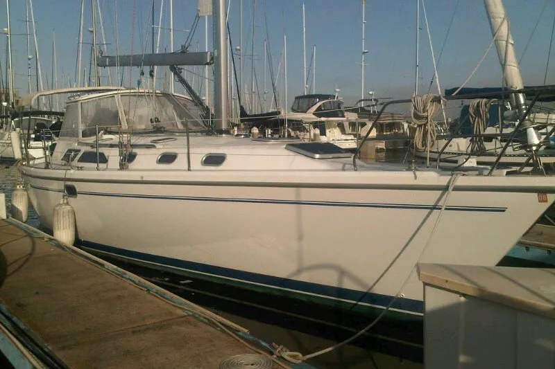 The Image of 2001 Catalina 42 MkII sailboat docked at a marina, surrounded by other boats. - 0