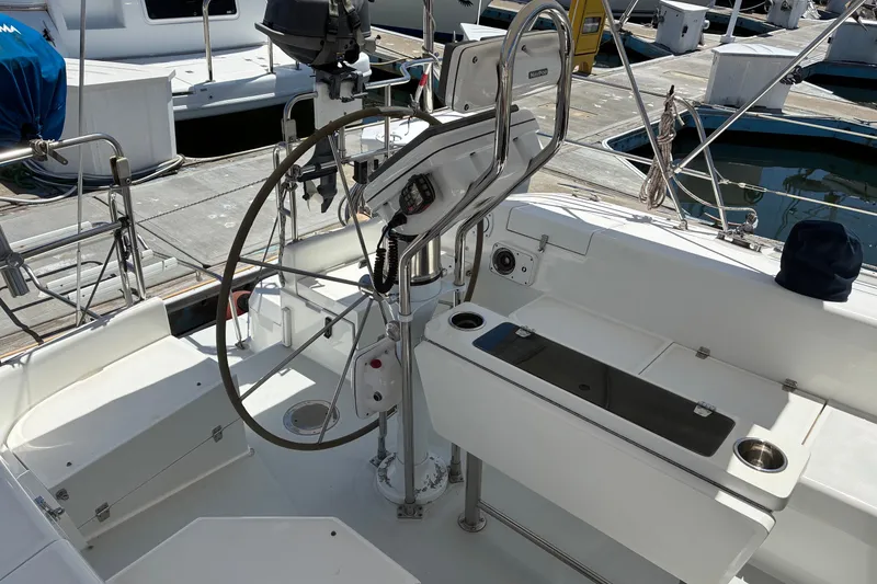 Slide: The Image of Cockpit of a 2001 Catalina 42 MkII sailboat, featuring a steering wheel and navigation equipment. - 21