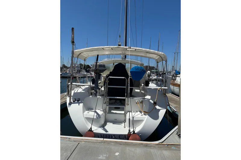 Slide: The Image of 2001 Catalina 42 MkII sailboat docked at marina under clear blue sky. - 23