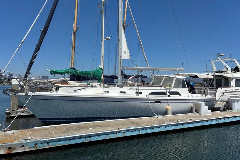 Slide: The Image of 2001 Catalina 42 MkII sailboat docked at marina under clear blue sky. - 25