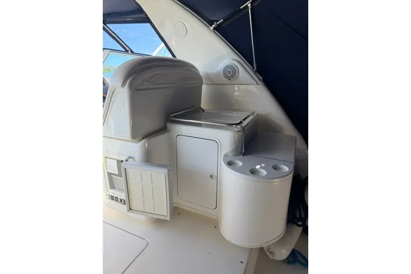 Slide: The Image of 1999 Sea Ray 330 Express Cruiser interior with storage and cup holders. - 6