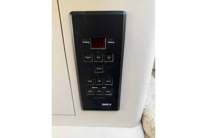 Slide: The Image of Control panel of a 1999 Sea Ray 330 Express Cruiser, featuring temperature and mode settings. - 7