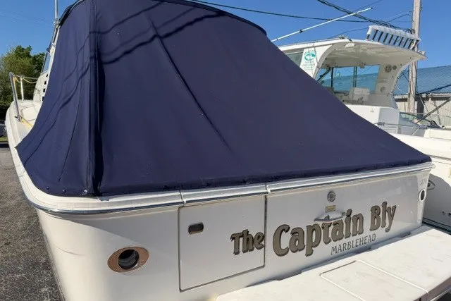 Slide: The Image of 1999 Sea Ray 330 Express Cruiser named "The Captain Bly" docked at Marblehead. - 9