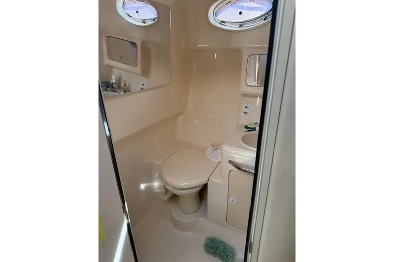 Slide: The Image of Bathroom interior of 1999 Sea Ray 330 Express Cruiser with toilet and sink. - 8