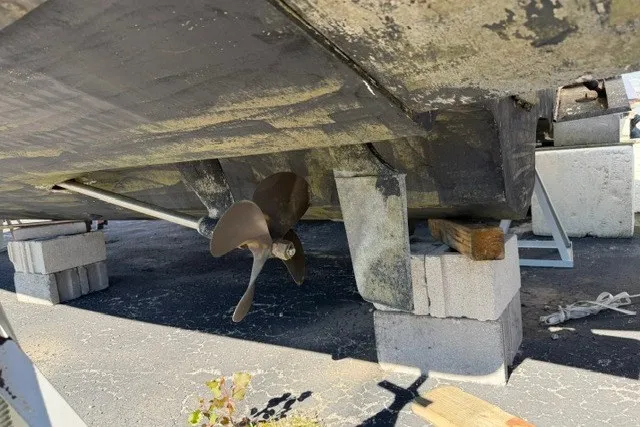 Slide: The Image of 1999 Sea Ray 330 Express Cruiser propeller and hull on blocks, dry docked. - 13