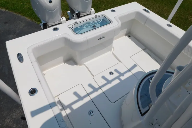 Slide: The Image of 2026 Pair Customs 24 Center Console DV Offshore boat deck with dual engines and storage compartments. - 8