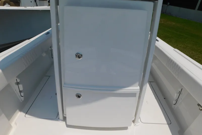 Slide: The Image of 2026 Pair Customs 24 Center Console DV Offshore boat interior, featuring sleek white storage compartments. - 37