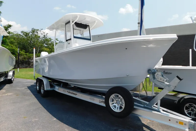 Slide: The Image of 2026 Pair Customs 24 Center Console DV Offshore boat on trailer, ready for adventure. - 2