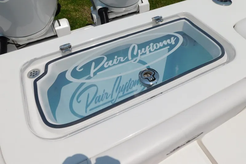 Slide: The Image of 2026 Pair Customs 24 Center Console DV Offshore boat livewell with logo. - 9