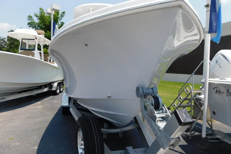 Slide: The Image of 2026 Pair Customs 24 Center Console DV Offshore boat on trailer, parked outdoors. - 26