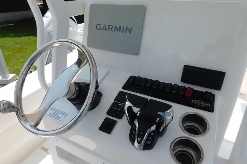 Slide: The Image of 2026 Pair Customs 24 Center Console DV Offshore helm with Garmin navigation and controls. - 5