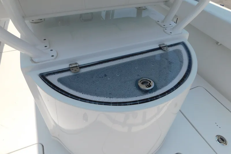 Slide: The Image of 2026 Pair Customs 24 Center Console DV Offshore boat livewell with water droplets. - 10