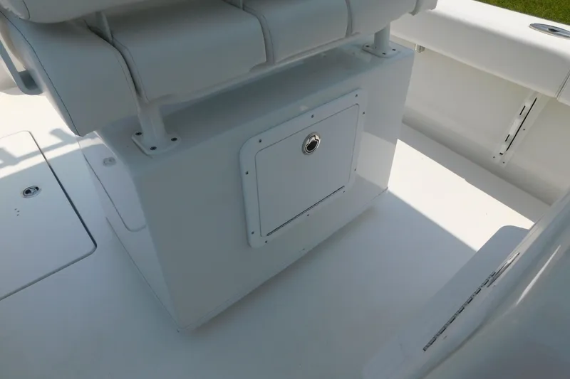 Slide: The Image of 2026 Pair Customs 24 Center Console DV Offshore boat interior with storage compartment. - 13