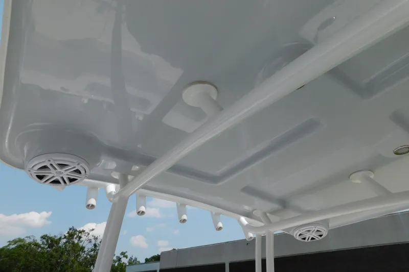 Slide: The Image of 2026 Pair Customs 24 Center Console DV Offshore boat roof with speakers and rod holders. - 17