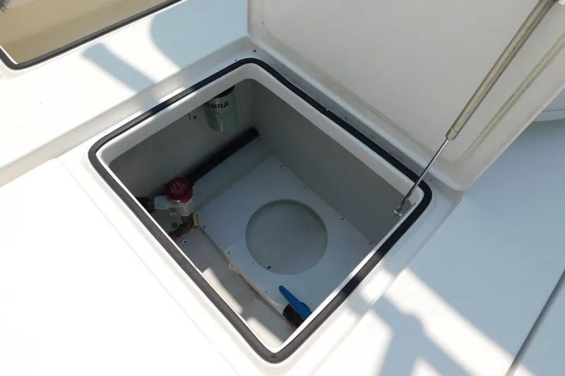 Slide: The Image of Open storage compartment on 2026 Pair Customs 24 Center Console DV Offshore boat. - 21