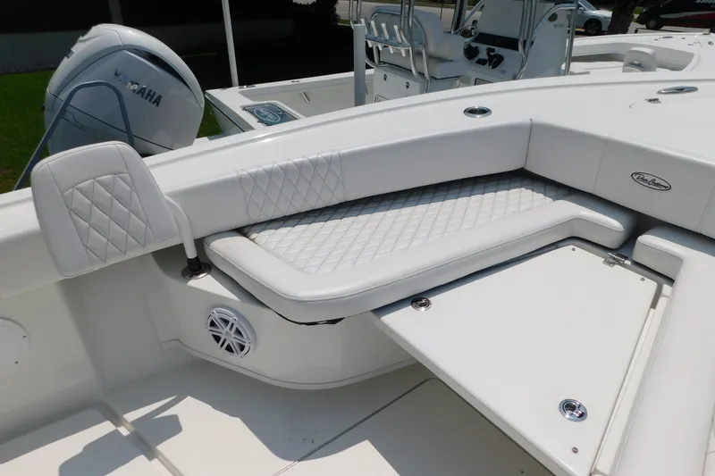 Slide: The Image of 2026 Pair Customs 24 Center Console DV Offshore boat interior with cushioned seating and Yamaha engine. - 35