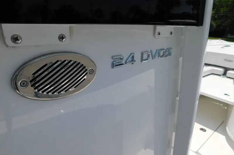 Slide: The Image of 2026 Pair Customs 24 Center Console DV Offshore boat detail with speaker and model emblem. - 24