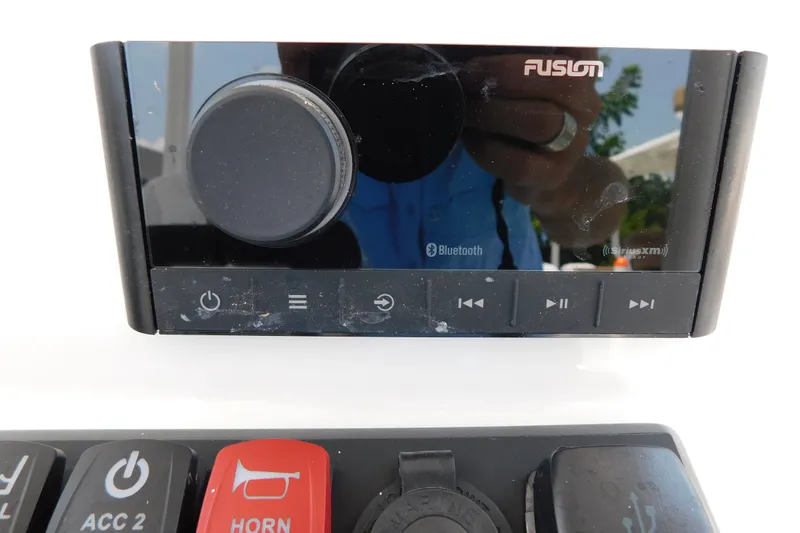 Slide: The Image of Control panel of a 2026 Pair Customs 24 Center Console DV Offshore boat with Fusion audio system. - 29