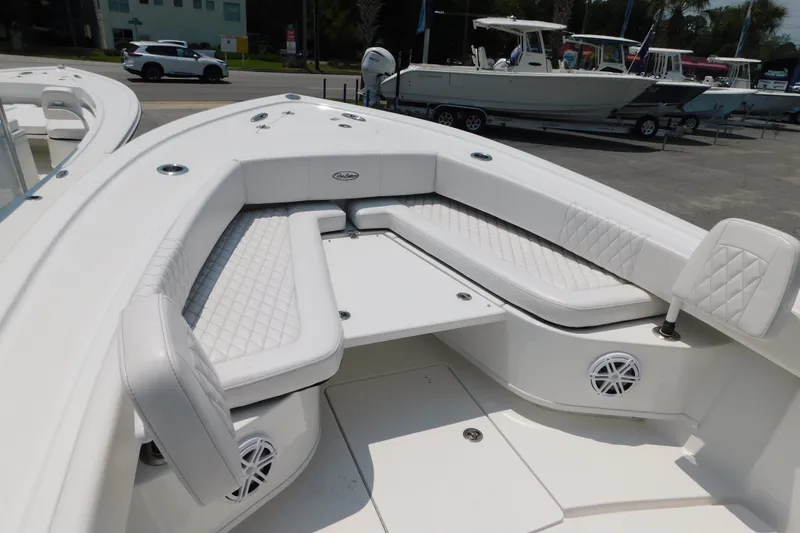 Slide: The Image of 2026 Pair Customs 24 Center Console DV Offshore boat with white cushioned seating. - 7