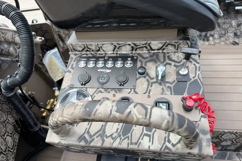 Slide: The Image of Control panel of 2026 Pro-Drive 2054 X TD Stick Steer boat with camouflage design. - 11