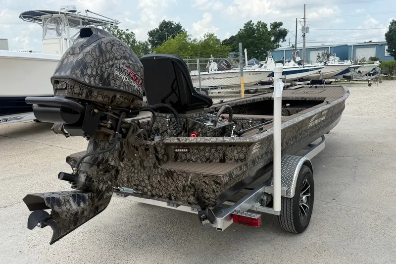 Slide: The Image of 2026 Pro-Drive 2054 X TD Stick Steer boat with camouflage design on a trailer. - 3
