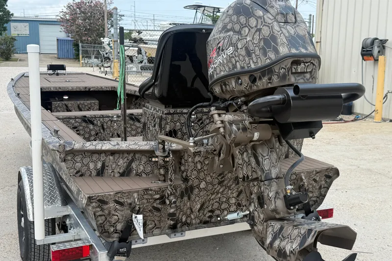 Slide: The Image of 2026 Pro-Drive 2054 X TD Stick Steer boat with camouflage design on a trailer. - 2
