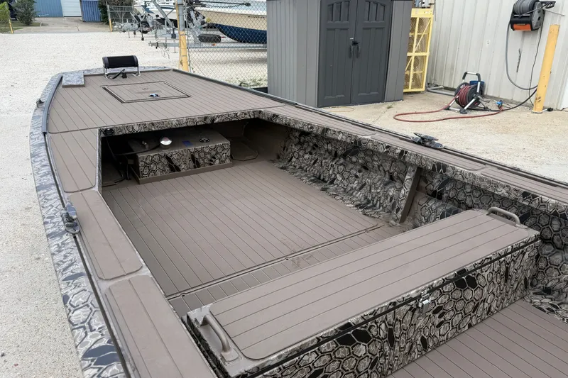 Slide: The Image of 2026 Pro-Drive 2054 X TD Stick Steer boat with camouflage interior, docked outdoors. - 9