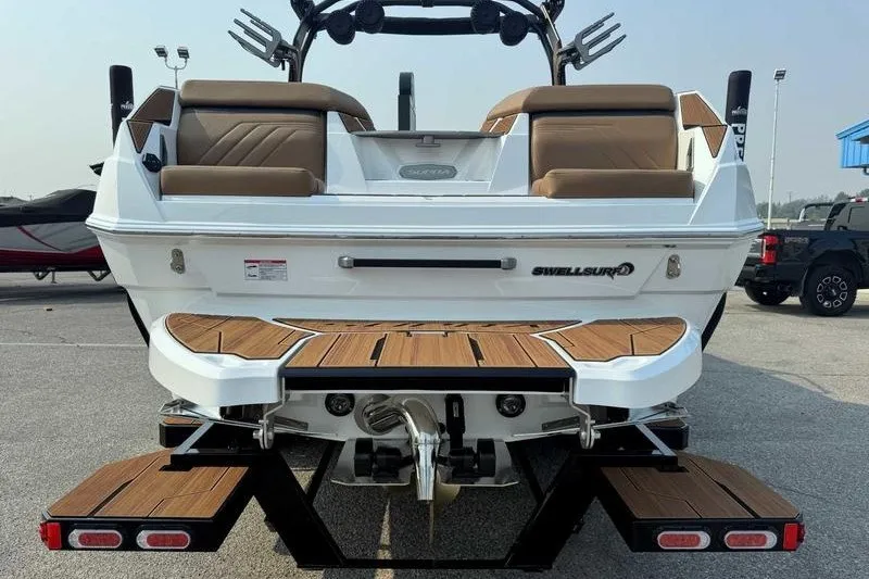Slide: The Image of 2027 Supra SR boat rear view with teak deck and SwellSurf system. - 6