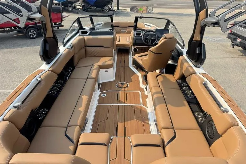 Slide: The Image of Luxurious 2027 Supra SR boat interior with tan seating and sleek design. - 12
