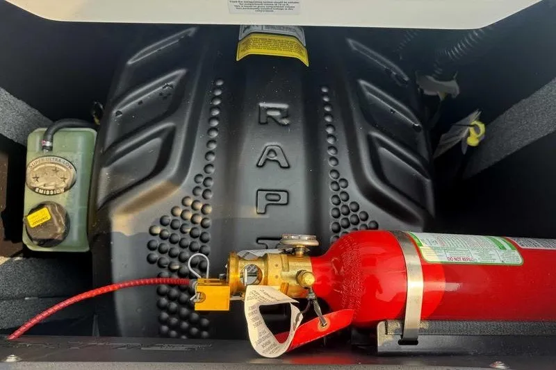 Slide: The Image of Engine compartment of 2027 Supra SR with fire extinguisher and fluid reservoir. - 20