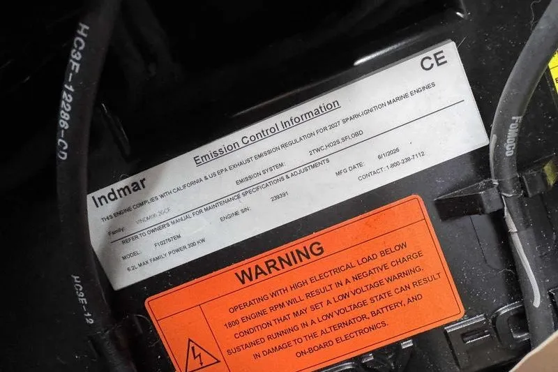 Slide: The Image of Emission control and warning labels on a 2027 Supra SR engine component. - 18