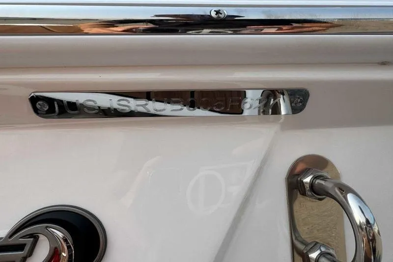 Slide: The Image of 2027 Supra SR boat with chrome details and registration number plate. - 14