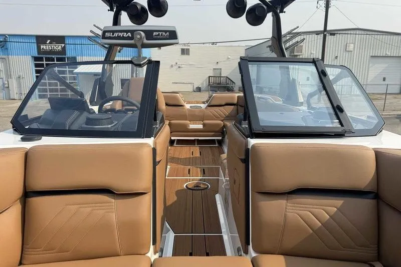 Slide: The Image of 2027 Supra SR boat interior with tan leather seats and modern dashboard. - 19