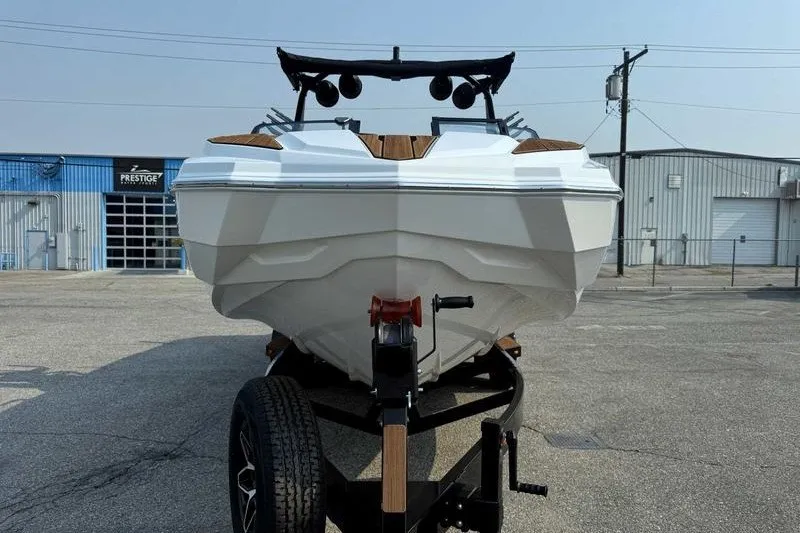 Slide: The Image of 2027 Supra SR boat on trailer in industrial parking lot. - 5