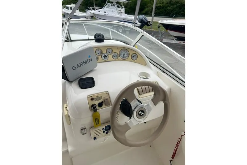 Slide: The Image of Steering console of a 2000 Larson Cabrio 254 boat with Garmin navigation system. - 8