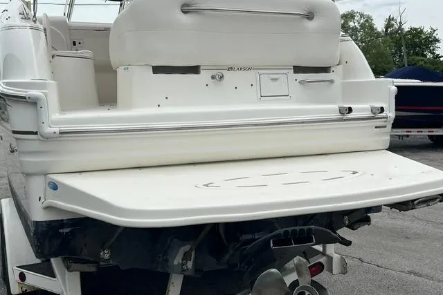Slide: The Image of Rear view of a 2000 Larson Cabrio 254 boat, showcasing the swim platform. - 17