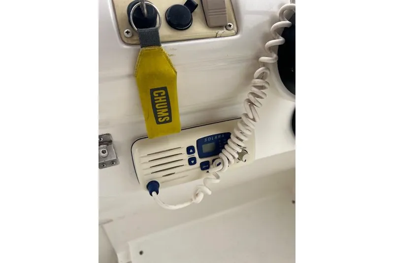 Slide: The Image of Control panel of a 2000 Larson Cabrio 254 boat with radio and keychain. - 10