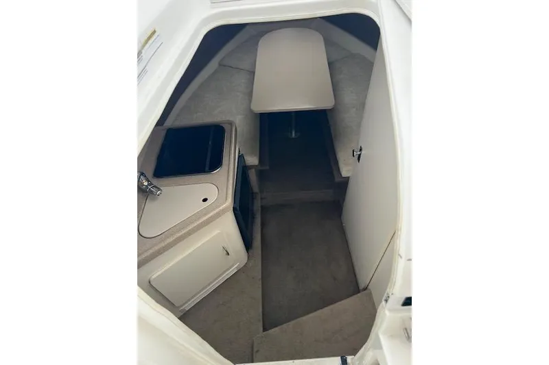 Slide: The Image of Interior cabin of 2000 Larson Cabrio 254 boat with kitchenette and seating area. - 3