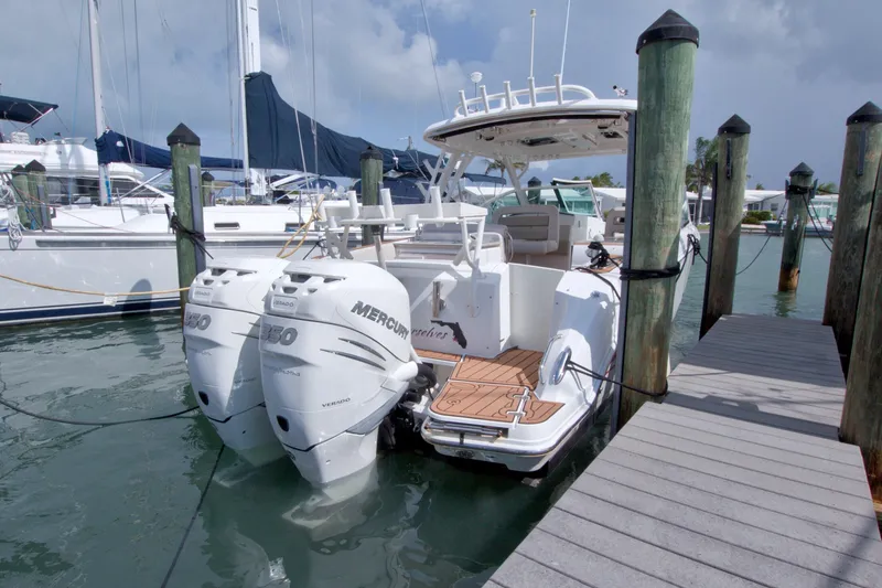 Slide: The Image of 2017 Boston Whaler 320 Vantage docked, featuring dual Mercury 350 engines. - 15