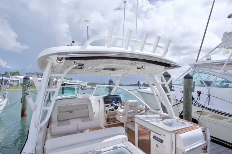 Slide: The Image of 2017 Boston Whaler 320 Vantage boat docked, showcasing spacious seating and modern amenities. - 24