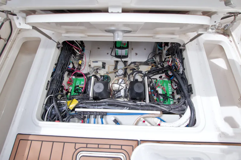 Slide: The Image of Engine compartment of a 2017 Boston Whaler 320 Vantage, showcasing wiring and components. - 55