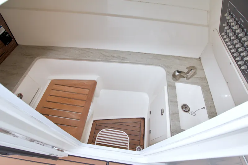 Slide: The Image of 2017 Boston Whaler 320 Vantage interior with wooden flooring and sink. - 40