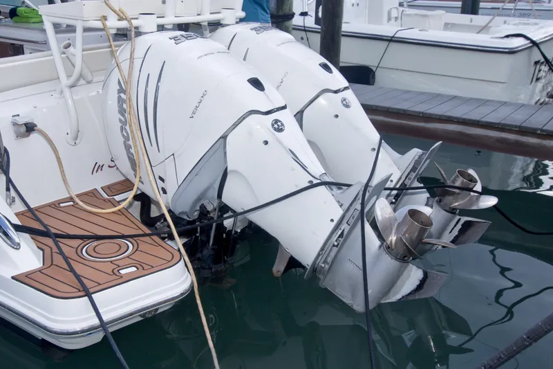 Slide: The Image of Twin Mercury outboard engines on a 2017 Boston Whaler 320 Vantage boat at dock. - 61