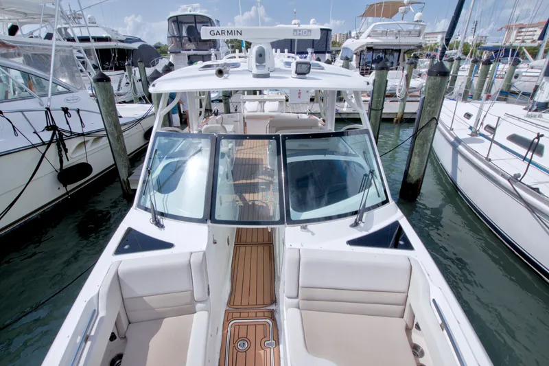 Slide: The Image of 2017 Boston Whaler 320 Vantage docked among other boats in a marina. - 45