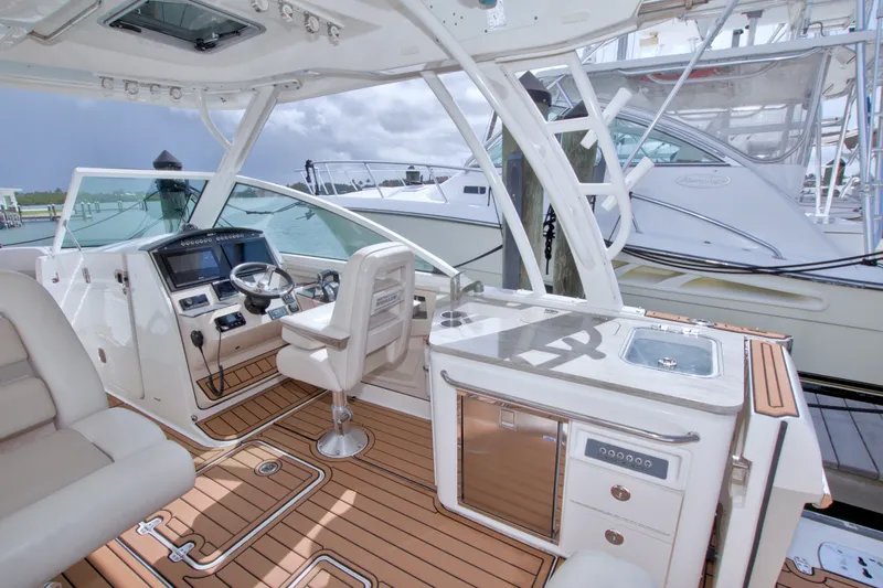 Slide: The Image of 2017 Boston Whaler 320 Vantage cockpit with helm, seating, and sleek design. - 32